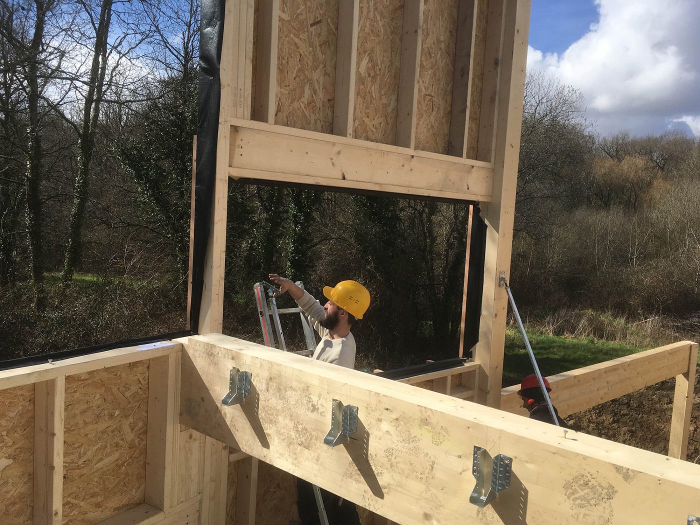 Charpentier travaillant sur une maison ossature bois
